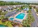 Aerial view of a community pool and hot tub with lounge chairs, surrounded by lush landscaping at 265 Connemara Dr. # D, Myrtle Beach, SC 29579