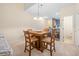 Cozy dining area with a wooden table set for four, open to a bright kitchen and inviting living space at 265 Connemara Dr. # D, Myrtle Beach, SC 29579