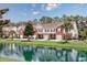 Attractive townhomes nestled alongside a tranquil pond with lush greenery and reflections on a beautiful day at 265 Connemara Dr. # D, Myrtle Beach, SC 29579