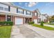 Charming townhome with brick accents, manicured landscaping, and private driveway leading to garage at 265 Connemara Dr. # D, Myrtle Beach, SC 29579