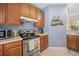 Well-equipped kitchen with stainless steel range, microwave, and ample cabinet space at 265 Connemara Dr. # D, Myrtle Beach, SC 29579