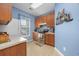 Cozy kitchen with wooden cabinets, stainless steel appliances and a charming nautical wall decoration at 265 Connemara Dr. # D, Myrtle Beach, SC 29579