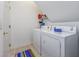 Functional laundry area featuring a washer, dryer, and storage shelving for convenience at 265 Connemara Dr. # D, Myrtle Beach, SC 29579