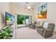 Comfortable living room with a view to the outdoors, ceiling fan, and cozy seating arrangement at 265 Connemara Dr. # D, Myrtle Beach, SC 29579