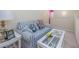 Inviting living room nook with blue striped sofa and a glass coffee table at 265 Connemara Dr. # D, Myrtle Beach, SC 29579