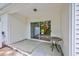 Covered patio provides shade and relaxation with a table and views of the lake and surrounding trees at 265 Connemara Dr. # D, Myrtle Beach, SC 29579