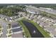 An aerial view shows neighborhood with pond, manicured lawns, and proximity to shopping and restaurants at 2989 Skylar Dr., Myrtle Beach, SC 29577