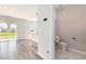 Half bath with marble floors adjacent to an open living room with sliding glass door and patio access at 2989 Skylar Dr., Myrtle Beach, SC 29577