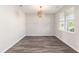 Bright dining room with hardwood floors, a modern light fixture, and a large window with natural light at 2989 Skylar Dr., Myrtle Beach, SC 29577