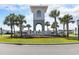 A community entrance features a manicured green space, an architectural tower, and well-maintained landscaping at 2989 Skylar Dr., Myrtle Beach, SC 29577