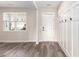 Welcoming entryway featuring hardwood floors, board and batten wainscoting, and a white front door at 2989 Skylar Dr., Myrtle Beach, SC 29577