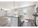 Open kitchen with granite countertops, stainless steel appliances, and an adjacent living area at 2989 Skylar Dr., Myrtle Beach, SC 29577