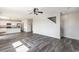 Spacious living room featuring gray wood floors and open access to the kitchen area at 2989 Skylar Dr., Myrtle Beach, SC 29577
