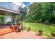 Backyard with a black spiral staircase leading to a deck with an outdoor seating area at 302 Sunnehanna Dr., Myrtle Beach, SC 29588