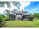 Backyard featuring a screened in porch, deck, and mature trees at 302 Sunnehanna Dr., Myrtle Beach, SC 29588