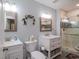 Bathroom featuring double sinks, white cabinets, a toilet, and a modern shower at 302 Sunnehanna Dr., Myrtle Beach, SC 29588