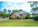 Charming two-story home with a brick facade and lush landscaping at 302 Sunnehanna Dr., Myrtle Beach, SC 29588