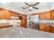 Open kitchen with granite countertops, oak cabinets, and stainless steel refrigerator at 302 Sunnehanna Dr., Myrtle Beach, SC 29588