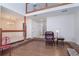 View of open floor plan, living room featuring hardwood floors, brick fireplace, and leather chair at 302 Sunnehanna Dr., Myrtle Beach, SC 29588