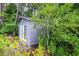 A detached outbuilding is surrounded by lush greenery and gardens at 302 Sunnehanna Dr., Myrtle Beach, SC 29588