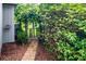 Lush foliage lines the brick walkway leading to a decorative gate and trellised archway at 302 Sunnehanna Dr., Myrtle Beach, SC 29588