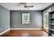 Neutral bedroom with wood floors, ceiling fan, and a door to the exterior at 303 Ayrie Ct., Conway, SC 29527