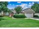 Charming home showcasing lush front lawn and well-maintained landscaping with an attached garage at 303 Ayrie Ct., Conway, SC 29527