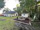 A charming backyard with a fire pit area, detached storage building, and partial view of the main house at 3048 Dewberry Dr., Conway, SC 29527