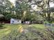 This backyard features a detached storage building and a cozy fire pit area perfect for outdoor gatherings at 3048 Dewberry Dr., Conway, SC 29527