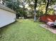 Enjoy the spacious backyard with an outdoor dining area and mature trees at 3048 Dewberry Dr., Conway, SC 29527