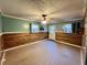 View of a finished basement room with wood accent walls, neutral paint, and natural light from nearby windows at 3048 Dewberry Dr., Conway, SC 29527