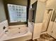 Bathroom featuring a large tub, a shower, and a glass block window for privacy at 3048 Dewberry Dr., Conway, SC 29527
