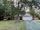 Charming single-story home with a well-maintained lawn and mature trees at 3048 Dewberry Dr., Conway, SC 29527
