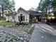 Charming exterior with stone-lined garden, lush landscaping, and walkway to the brick-lined porch at 3048 Dewberry Dr., Conway, SC 29527