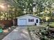 Exterior view of detached garage with white door, convenient side door access, and well-maintained landscaping at 3048 Dewberry Dr., Conway, SC 29527