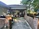 A covered patio space with brick accents, offering a comfortable area for outdoor living and entertaining guests at 3048 Dewberry Dr., Conway, SC 29527