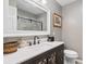Modern bathroom with quartz countertops, dark vanity and a shower with glass doors at 308 Old Stage Rd., Mullins, SC 29574