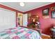 Comfortable bedroom with hardwood floors, red walls, and a white closet door at 308 Old Stage Rd., Mullins, SC 29574