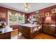 Charming bedroom with hardwood floors, a decorative wooden bed frame, and natural light from the window at 308 Old Stage Rd., Mullins, SC 29574