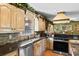 Charming kitchen featuring granite countertops, stainless steel appliances, and custom wooden cabinetry at 308 Old Stage Rd., Mullins, SC 29574
