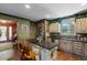 Well-equipped kitchen featuring custom cabinets, stone countertops, and a serving bar at 308 Old Stage Rd., Mullins, SC 29574
