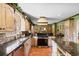 Spacious kitchen with a large island, tile flooring, and a modern stainless steel dishwasher at 308 Old Stage Rd., Mullins, SC 29574