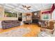 Warm and inviting living room with a brick fireplace, hardwood floors, and a coffered ceiling at 308 Old Stage Rd., Mullins, SC 29574