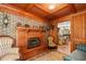 Elegant living room featuring a fireplace, exposed brick, and wood coffered ceilings at 308 Old Stage Rd., Mullins, SC 29574