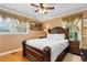Comfortable bedroom featuring wood floors, a decorative headboard, and bright natural light from windows at 308 Old Stage Rd., Mullins, SC 29574