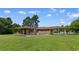 Spacious backyard showcasing the home's brick exterior, covered patio and carport at 308 Old Stage Rd., Mullins, SC 29574