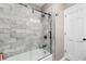 Modern shower and bathtub with white tile walls and a sliding glass door at 308 Old Stage Rd., Mullins, SC 29574