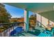 Balcony view showcasing outdoor seating and a covered pool in a well-maintained condominium community at 311 69Th Ave. N # 302, Myrtle Beach, SC 29572