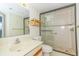 Modern bathroom with a glass-enclosed shower, a wooden shelf, and neutral-toned tile walls at 311 69Th Ave. N # 302, Myrtle Beach, SC 29572