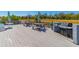 Outdoor deck featuring picnic tables, chairs, a grill, and a scenic view of the natural surroundings at 311 69Th Ave. N # 302, Myrtle Beach, SC 29572